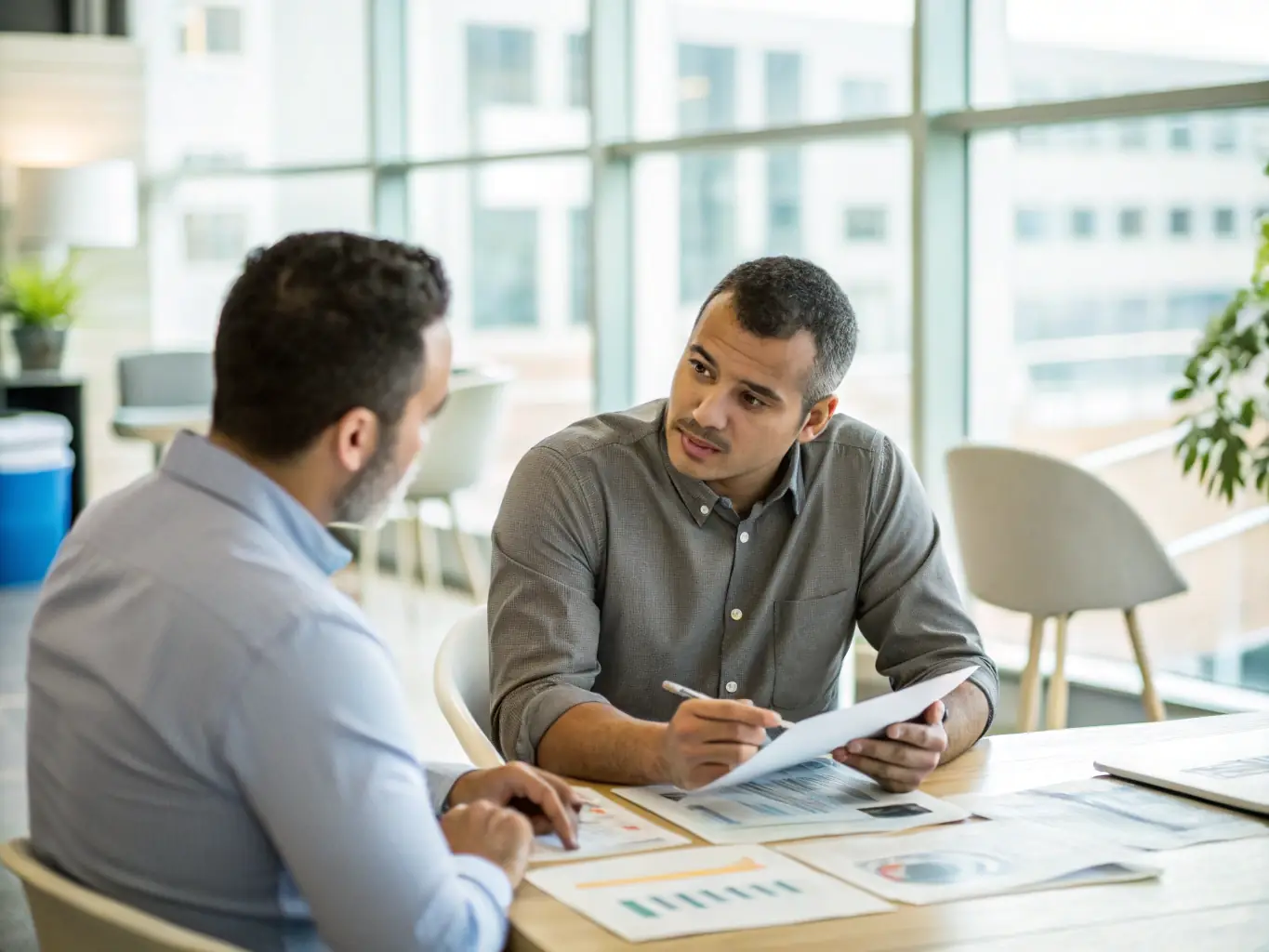 A South African business owner discussing tax strategies with a financial advisor in a sunny office, showcasing personalized service.